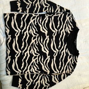 Loose fit.  Zebra pattern top .  Almost a fleece feel